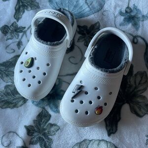 White and gray plush crocs with jibitts